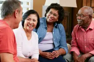 Group Of Senior Friends Chatting At Home Together