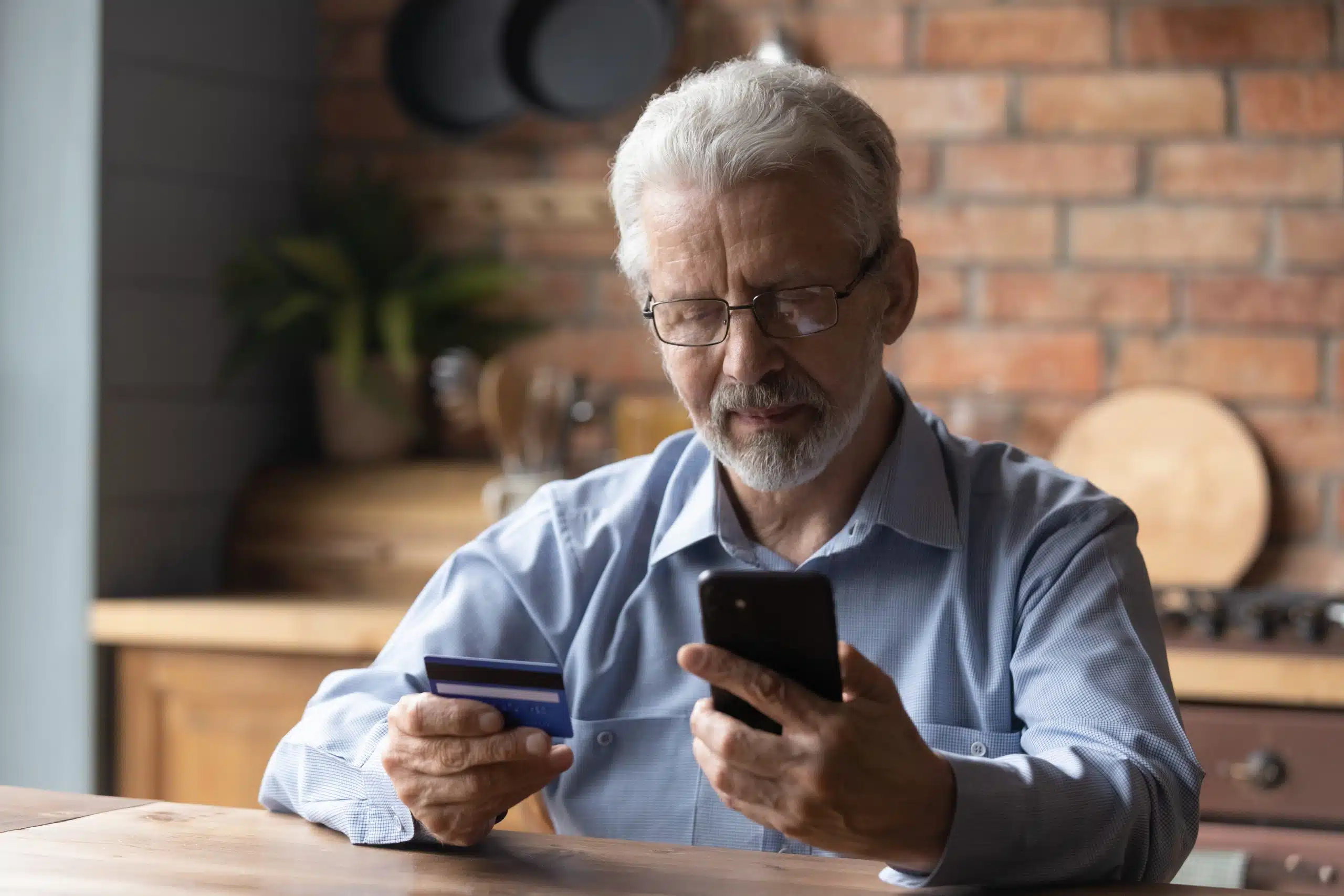 mature retired man shopping in mobile app.