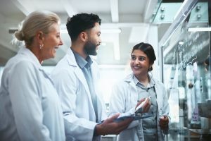 three researchers working together in lab.
