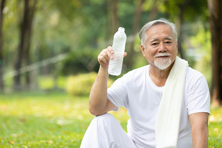 asian man exercising outside hothydrating.jpeg