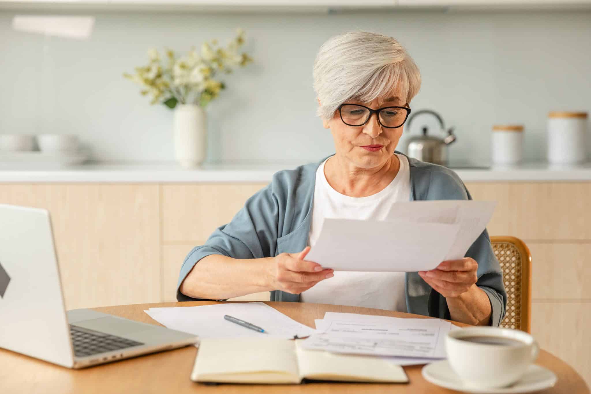 Middle aged senior woman sit with laptop